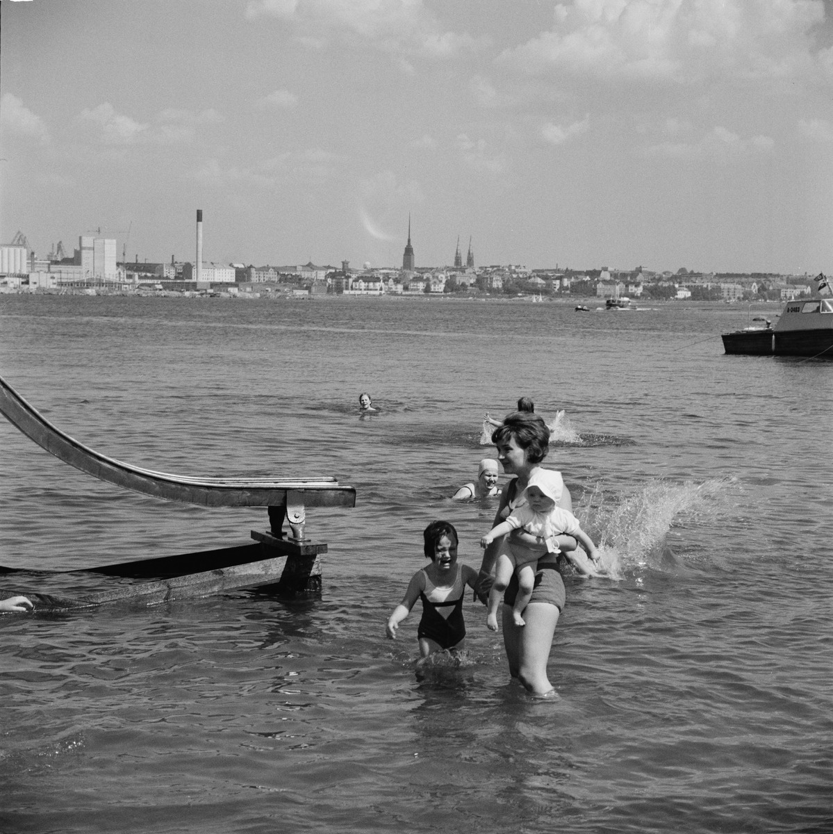 Äiti ja lapset meressä Pihlajasaaren hiekkarannalla
